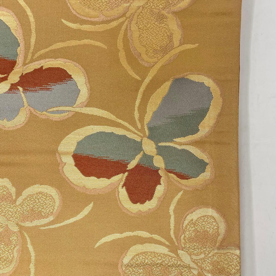 ［ 名古屋帯/ポリエステル ］化繊　柔らかい橙系の色　蝶　洗濯　洗える