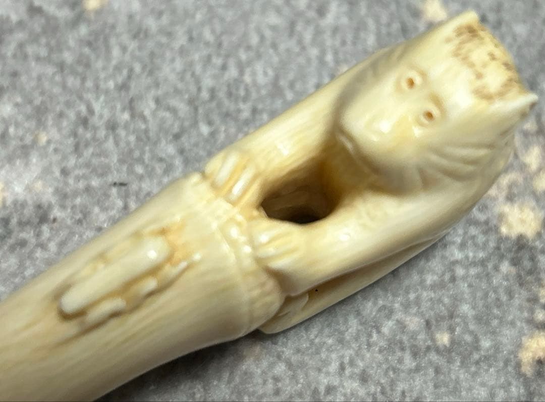 根付 竹の子に止まりバッタを見つめる猿の姿をしている根付