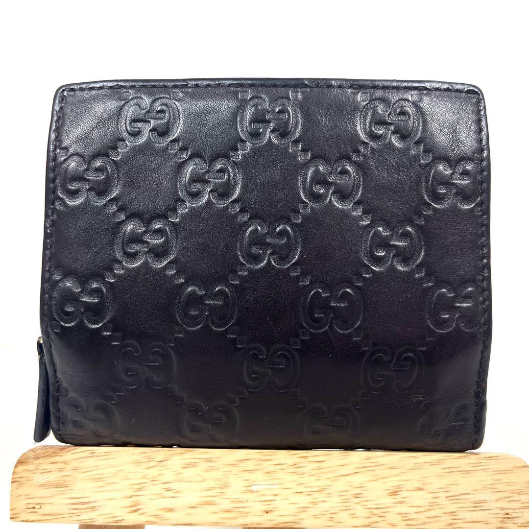 グッチ　二つ折り財布　アビー　シマレザー　ラウンドファスナー　ロゴ　エンボス