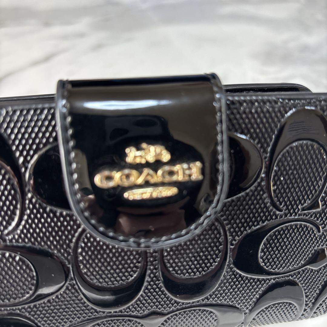 【美品】COACH コーチ 折り財布シグネチャーエンボス加工パテントレザー　黒