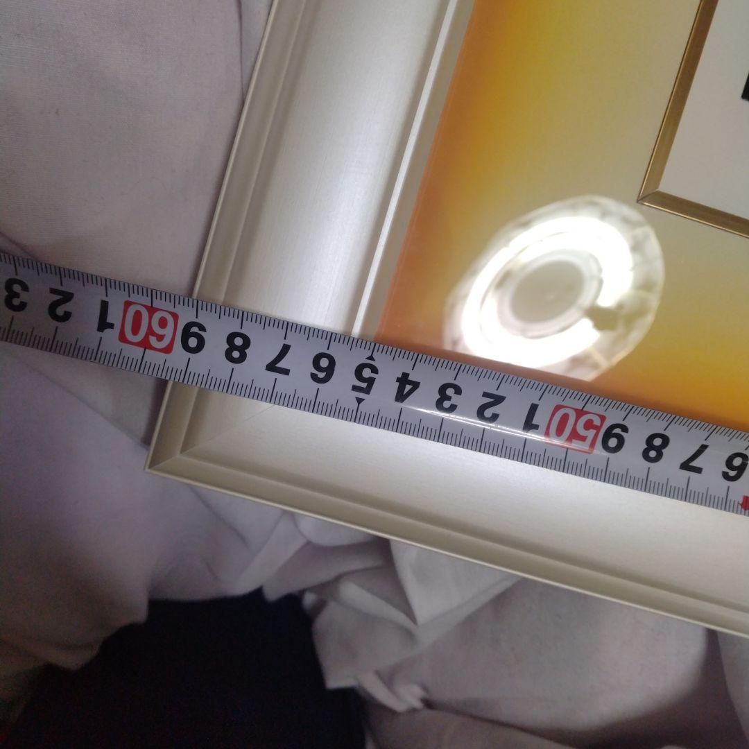 題名夕焼けの海、作者 Kim 、版画Ｎｏ．8/100です。