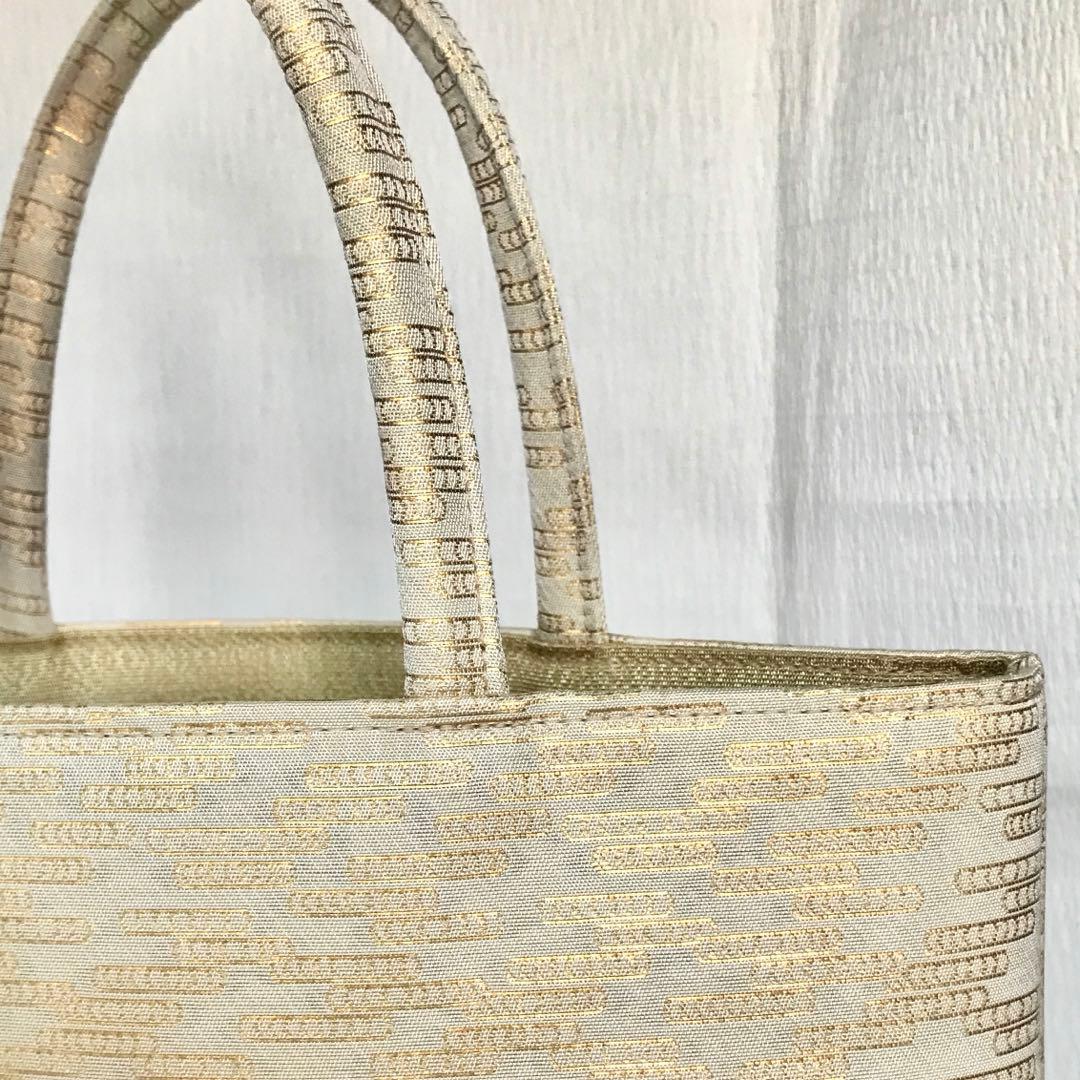 美品　伊と忠　金襴サブバッグ　観世水柄