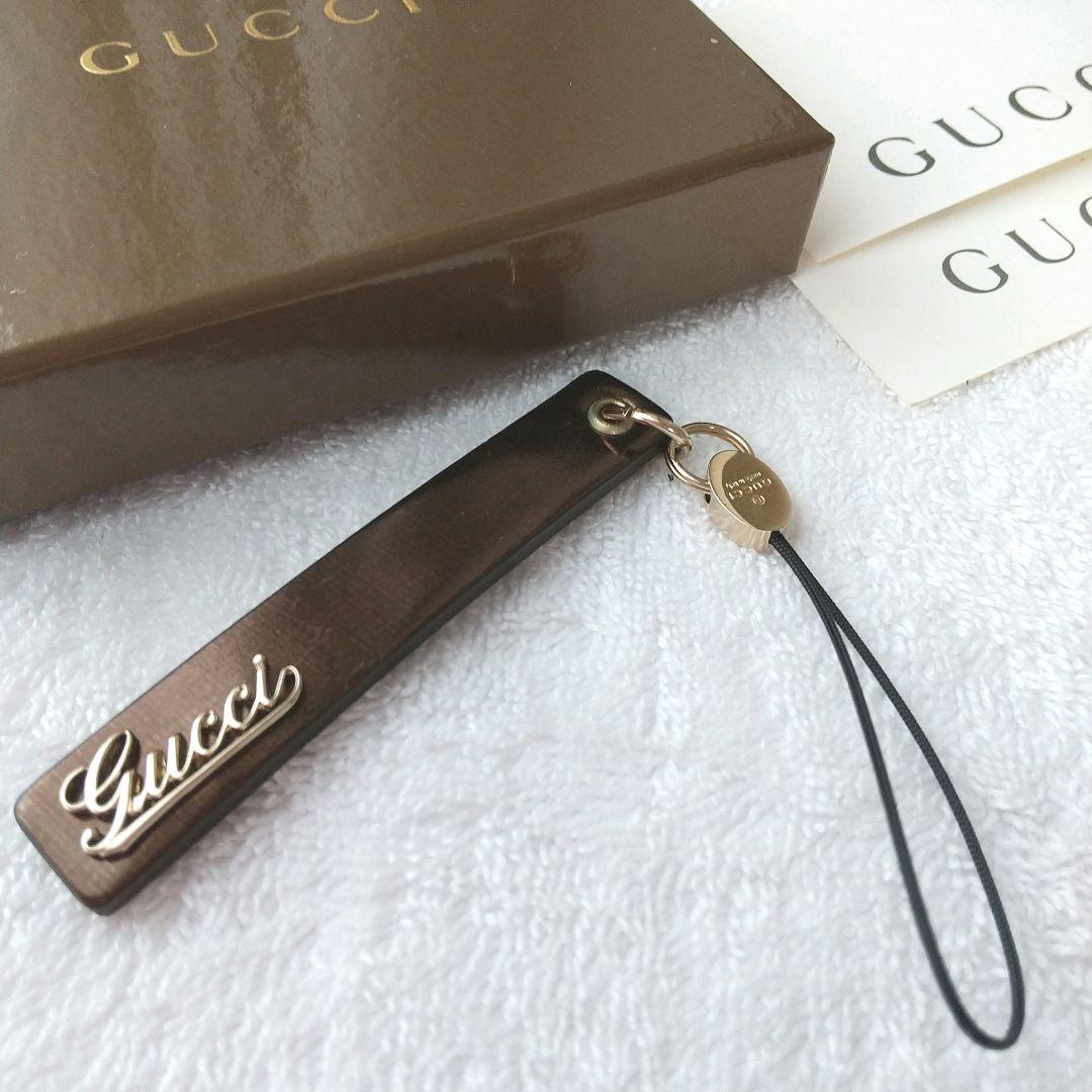 【新品 】 グッチ ストラップ GUCCI 筆記体ロゴ レザー 廃盤 ゴールド